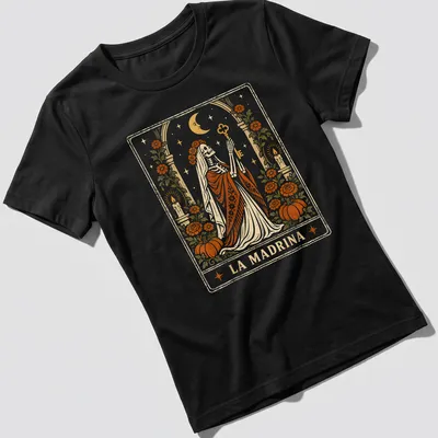 Vintage tarot card style t-shirt featuring a skeleton in a robe with LA MADRINA text — printed on a women's shirt