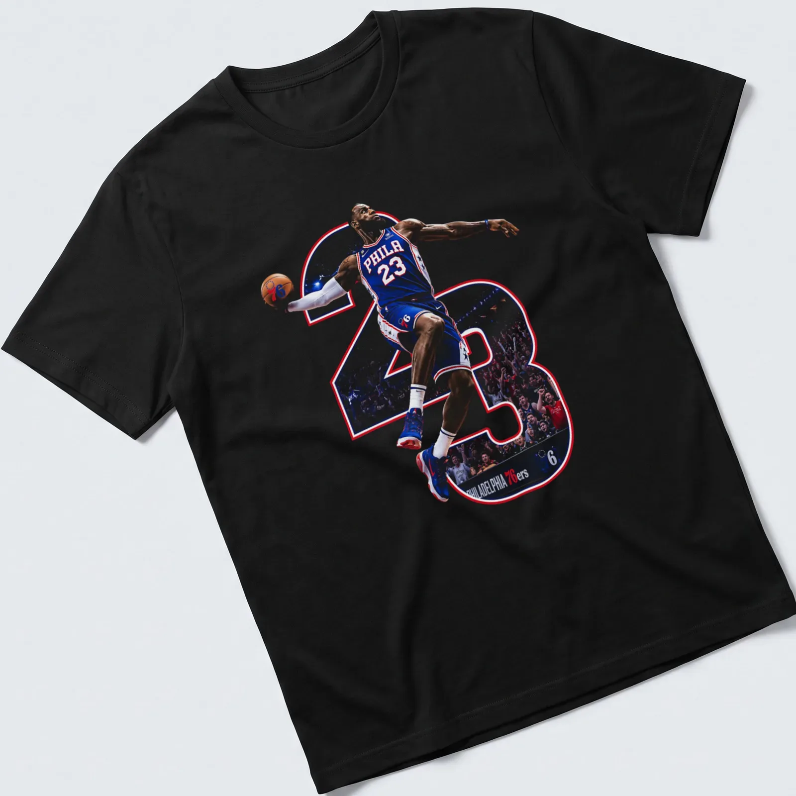 Dynamic illustration of LeBron James with 'PHILA 23' printed in blue, red, and white. — printed on a unisex t-shirt