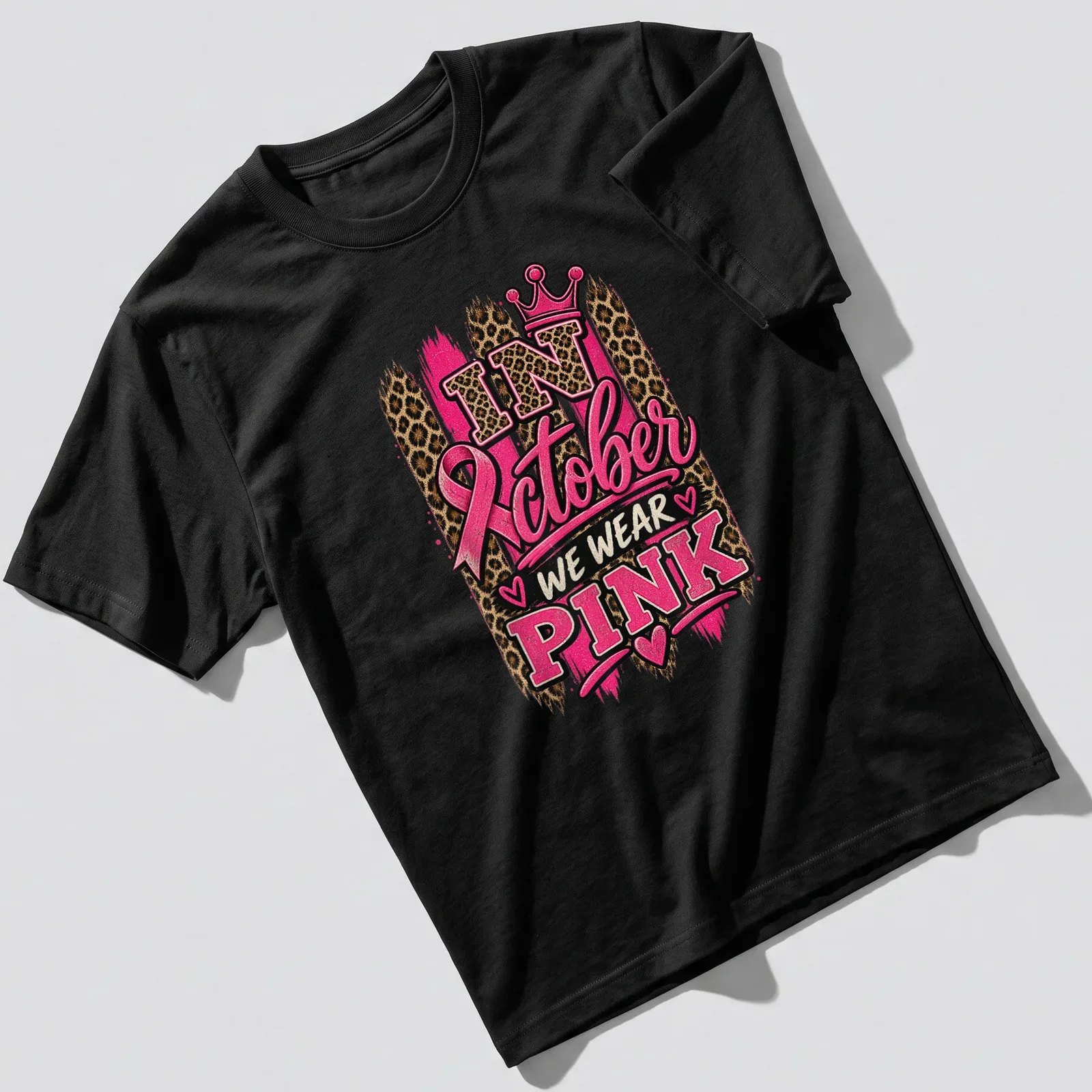 Bold typography and leopard print design with crown in pink and gold — printed on a unisex t-shirt