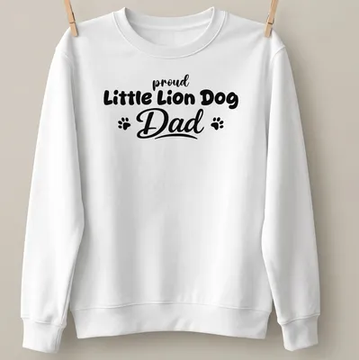 Bold typography t-shirt stating 'proud Little Lion Dog Dad' with playful Little Lion Dog illustration — printed on a unisex sweatshirt