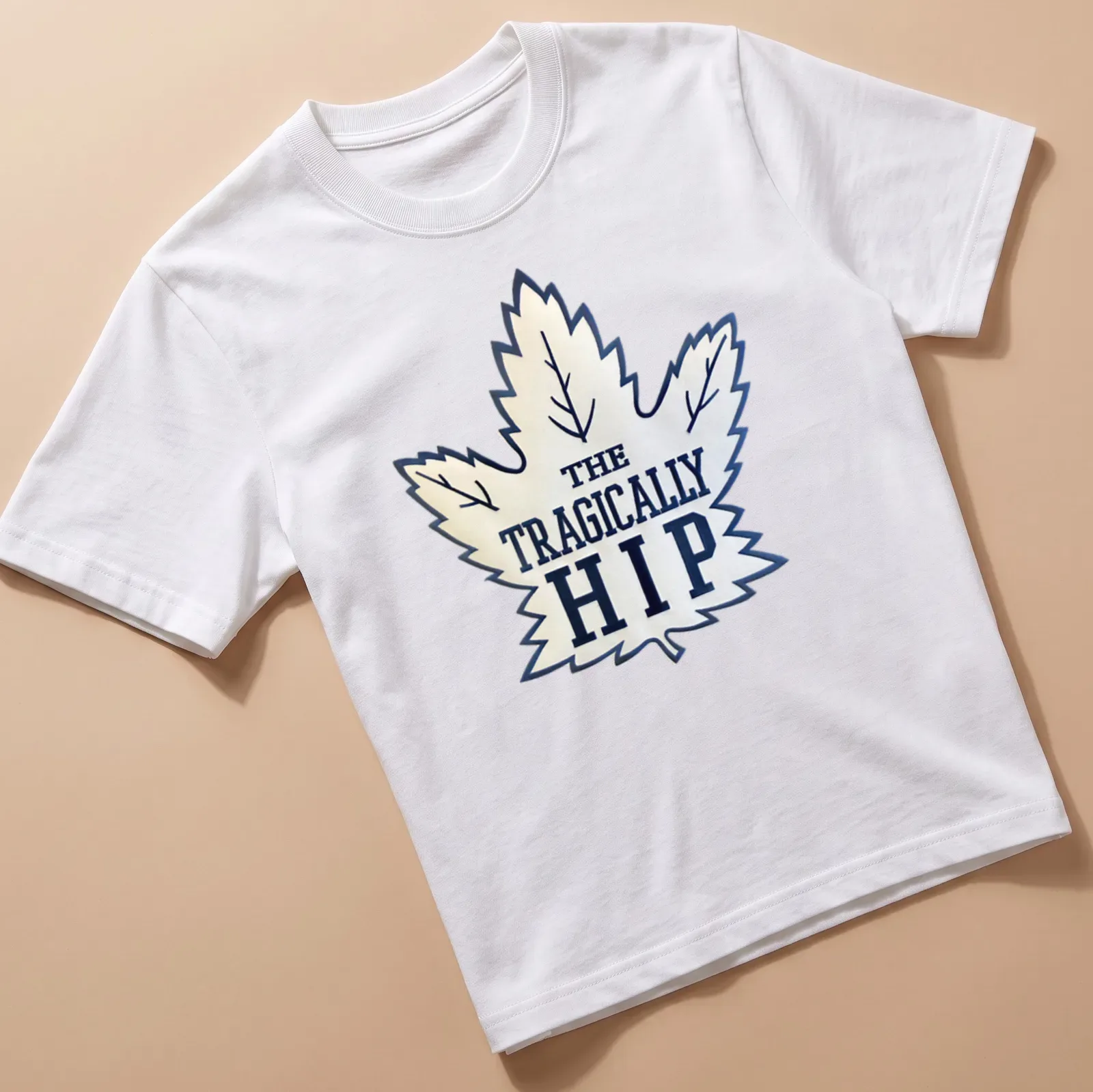Bold graphic of The Tragically Hip with a maple leaf in white and navy — printed on a unisex t-shirt