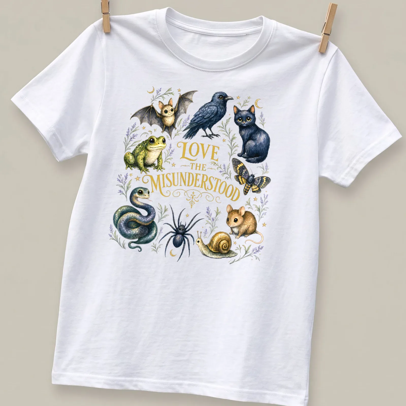 Whimsical illustration of various misunderstood animals with the text 'LOVE THE MISUNDERSTOOD' — printed on a unisex t-shirt