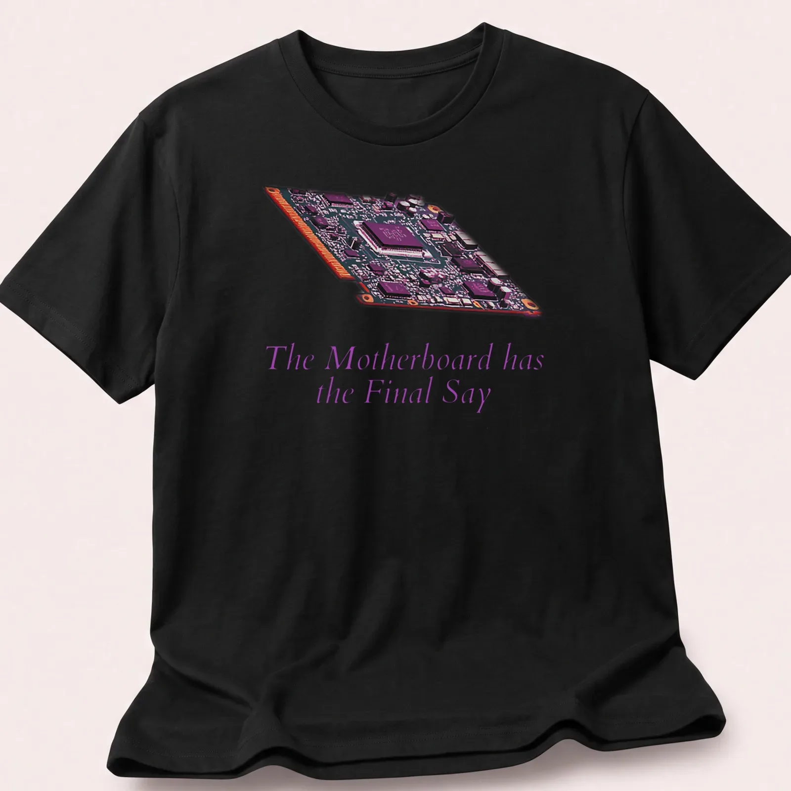 Digital illustration of a motherboard with bold text: The Motherboard has the Final Say — printed on a unisex t-shirt