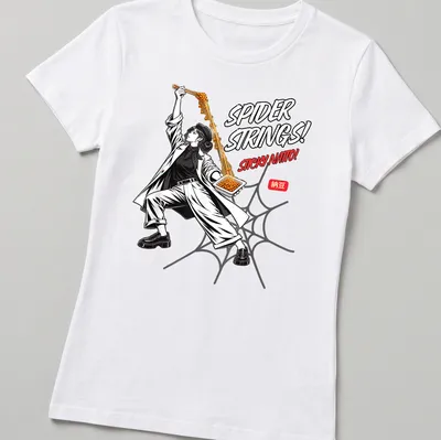 Comic-style graphic of a person holding sticky natto with humorous text — printed on a women's shirt