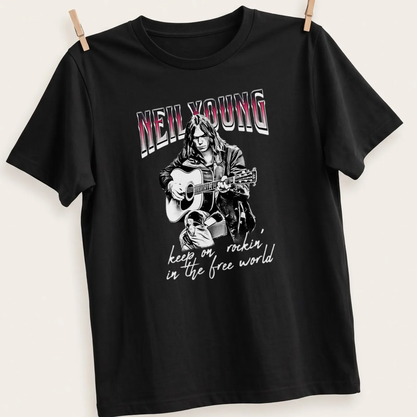 Black and white sketch of Neil Young with the text 'keep on rockin' in the free world' in red — printed on a unisex t-shirt