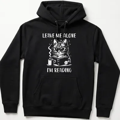 Cute illustration of a nerdy cat reading a book with the text Leave Me Alone I'm Reading — printed on a unisex hoodie