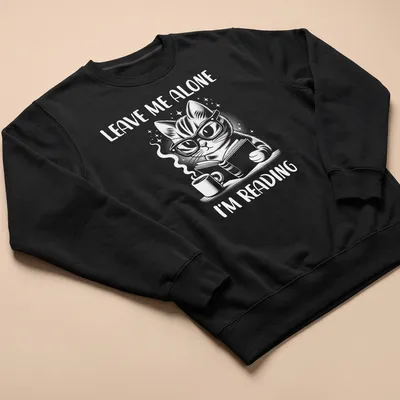 Cute illustration of a nerdy cat reading a book with the text Leave Me Alone I'm Reading — printed on a unisex sweatshirt