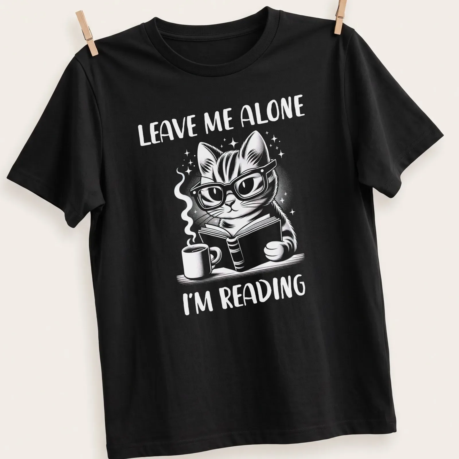 Cute illustration of a nerdy cat reading a book with the text Leave Me Alone I'm Reading — printed on a unisex t-shirt