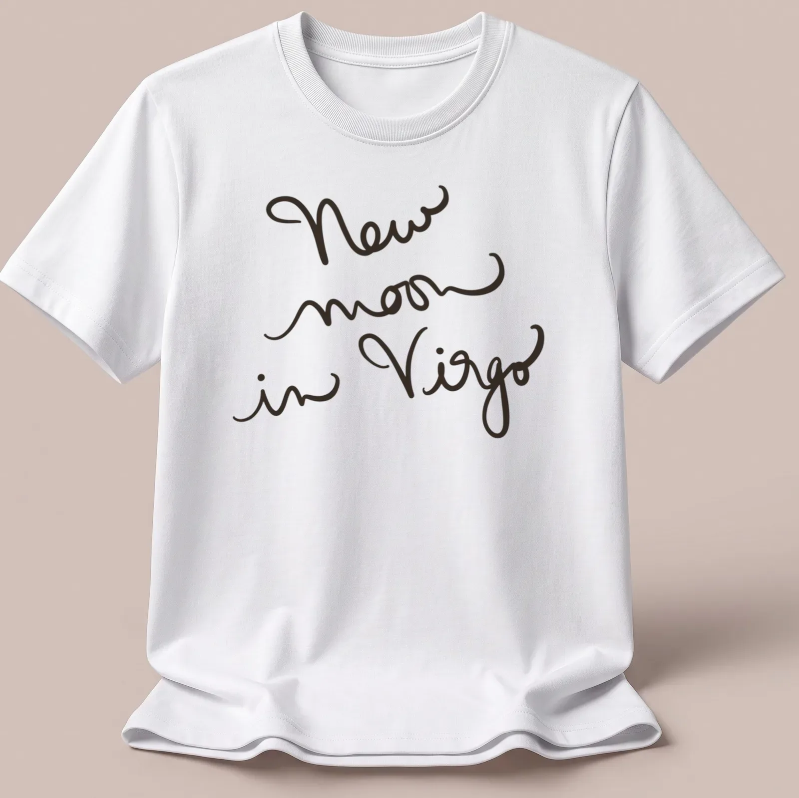 Handwritten script design reading 'New moon in Virgo' in black text — printed on a unisex t-shirt