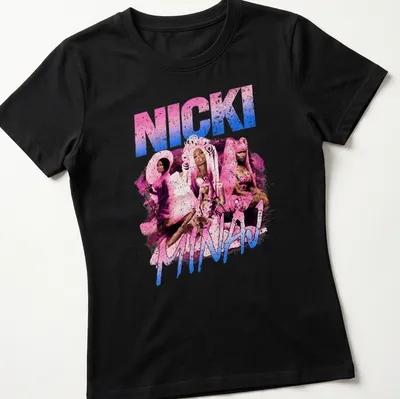 Pop art design featuring Nicki Minaj in vibrant pink, blue, white, and black colors. — printed on a women's shirt