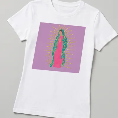 Colorful illustration of Our Lady Of Guadalupe in pink, teal, and gold — printed on a women's shirt