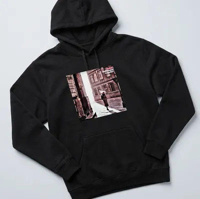 Vintage style shirt featuring a person in a trench coat labeled 'camel stationary traveller' — printed on a unisex hoodie