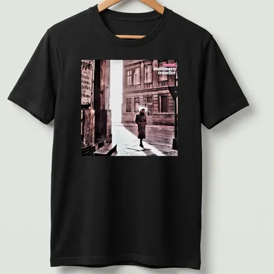 Vintage style shirt featuring a person in a trench coat labeled 'camel stationary traveller'