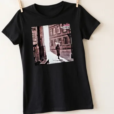 Vintage style shirt featuring a person in a trench coat labeled 'camel stationary traveller' — printed on a women's shirt