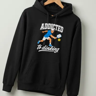 Bold printed text 'ADDICTED to dinking' with a Pickleball player design — printed on a unisex hoodie