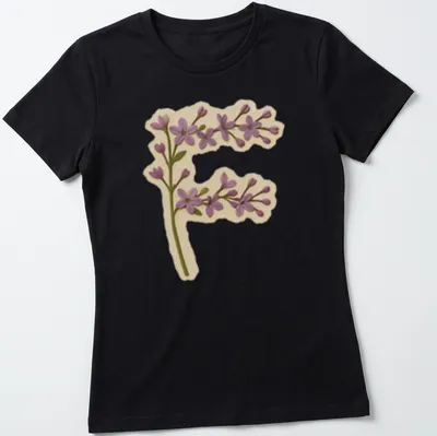 Vintage floral shirt featuring a large letter F adorned with purple lilac flowers. — printed on a women's shirt