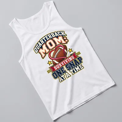 Bold, colorful text reads 'Quarterback Mom: Surviving One Snap at a Time' with football imagery — printed on a tank top
