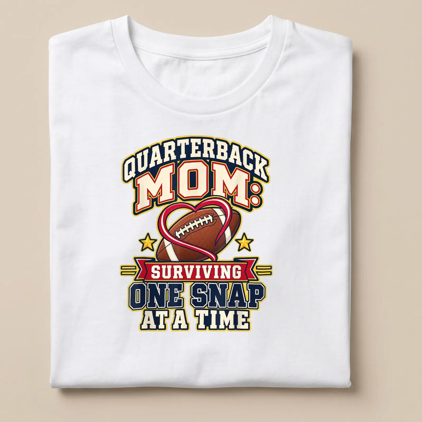 Bold, colorful text reads 'Quarterback Mom: Surviving One Snap at a Time' with football imagery — printed on a unisex t-shirt