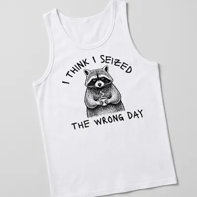 Detailed line-art of a raccoon holding a coffee cup with humorous text about seizing the day — printed on a tank top