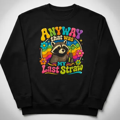 Colorful cartoon raccoon holding a straw with humorous text above. — printed on a unisex sweatshirt
