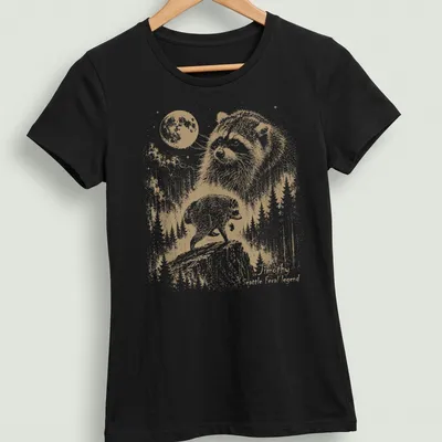 Vintage illustration of a raccoon with text reading Timothy Seattle feral legend — printed on a women's shirt