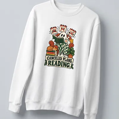 Whimsical ghost reading a book with text 'CANCELLED PLANS. READING.' in playful design — printed on a unisex sweatshirt