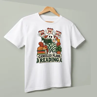Whimsical ghost reading a book with text 'CANCELLED PLANS. READING.' in playful design — printed on a unisex t-shirt (angled view)