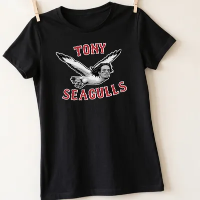 Bold graphic tee featuring seagulls with a man's face and playful slogan — printed on a women's shirt