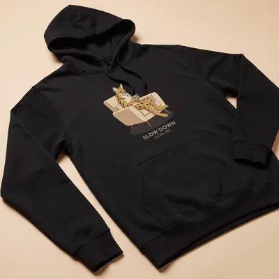 Retro graphic of a Serval cat playing a handheld console with the text Slow Down (Level Up) — printed on a unisex hoodie