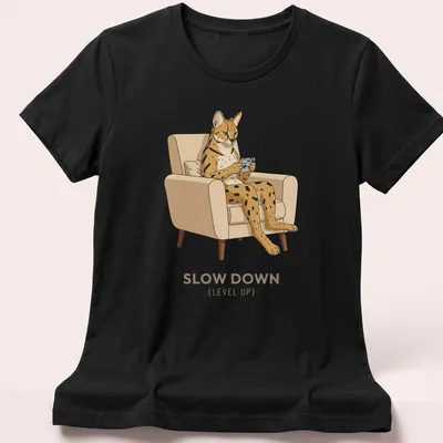 Retro graphic of a Serval cat playing a handheld console with the text Slow Down (Level Up) — printed on a women's shirt