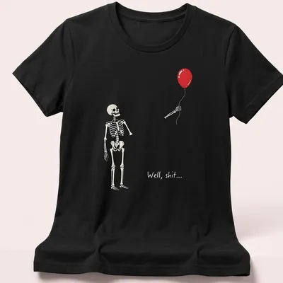 Cartoon skeleton holding a red balloon with the text 'Well, shit...' — printed on a women's shirt