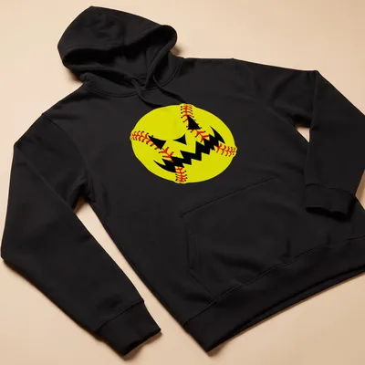 Cartoon pumpkin jack-o'-lantern face resembling a softball in yellow, black, and red — printed on a unisex hoodie