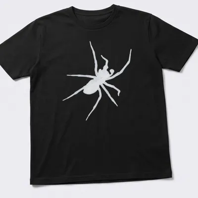 Bold black and white illustration of a spider on a dark t-shirt