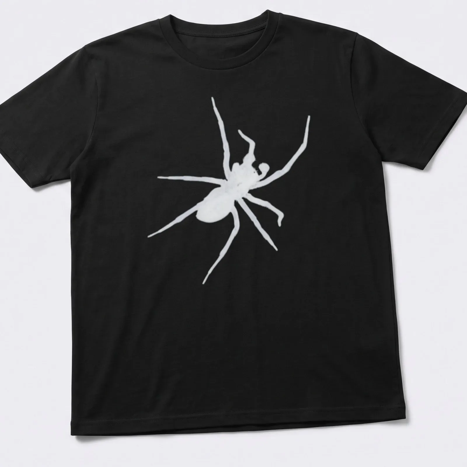Bold black and white illustration of a spider on a dark — printed on a unisex t-shirt