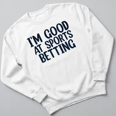 Black t-shirt with bold typography stating I'm Good At Sports Betting. — printed on a unisex sweatshirt