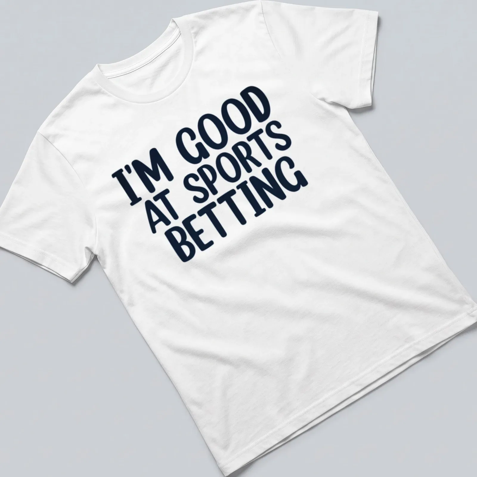 Black t-shirt with bold typography stating I'm Good At Sports Betting. — printed on a unisex t-shirt