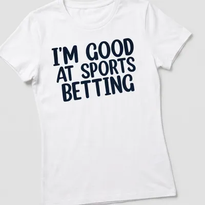 Black t-shirt with bold typography stating I'm Good At Sports Betting. — printed on a women's shirt