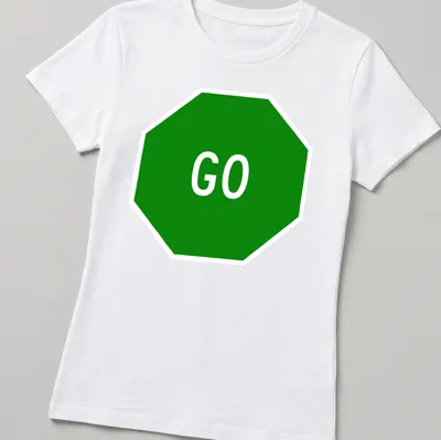 Graphic t-shirt featuring a green stop sign with the word GO in bold white letters — printed on a women's shirt