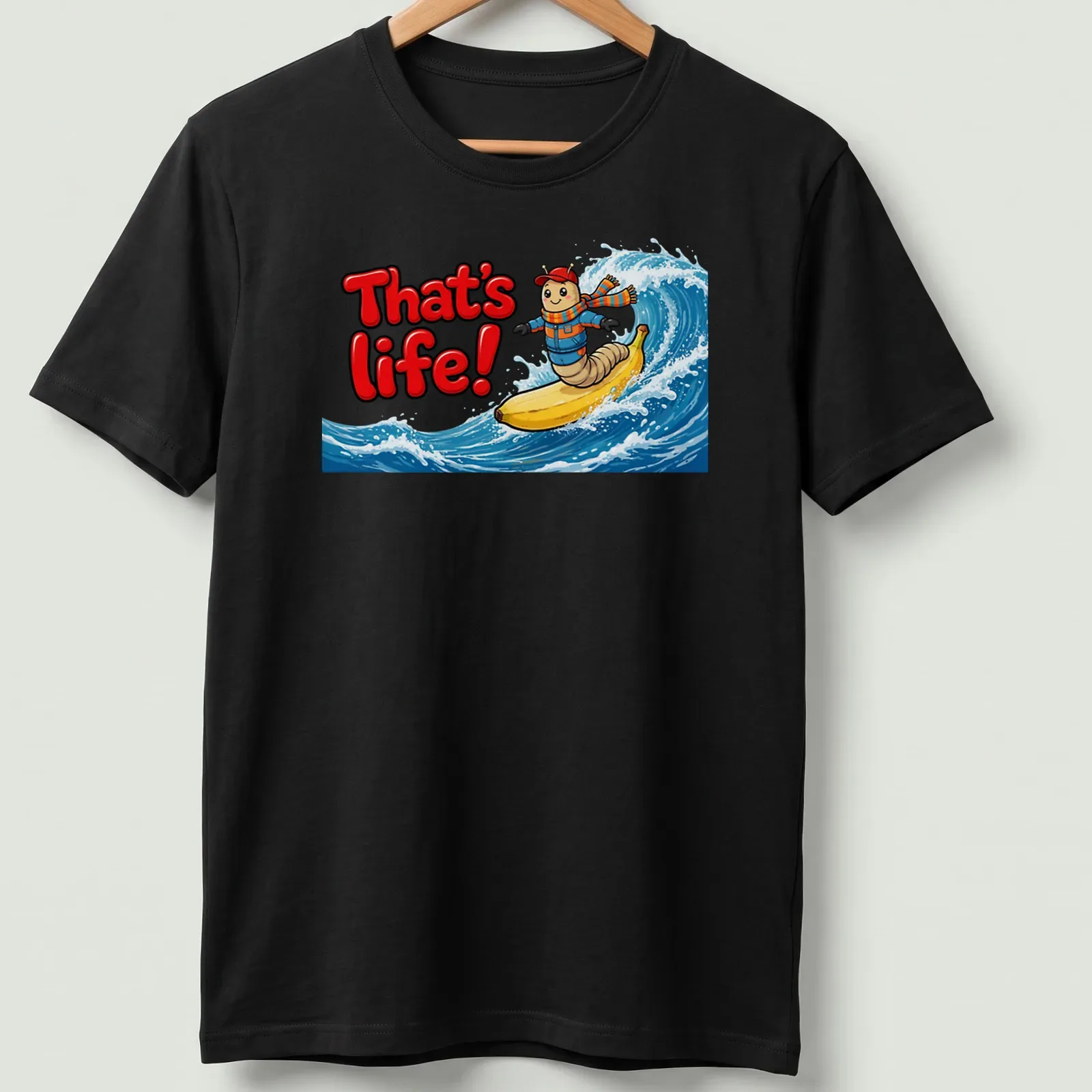 Cartoon design of a worm surfing on a banana with text 'That's life!' — printed on a unisex t-shirt