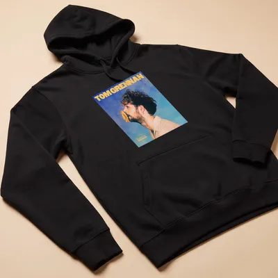 Vintage-style Tom Grennan Gospel Version t-shirt with blue, yellow, and beige colors. — printed on a unisex hoodie