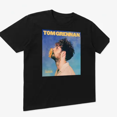 Vintage-style Tom Grennan Gospel Version t-shirt with blue, yellow, and beige colors. — printed on a unisex t-shirt (angled view)