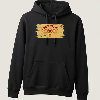 Bold graphic t-shirt featuring uterus and DON'T TREAD text in yellow and red — printed on a unisex hoodie