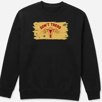 Bold graphic t-shirt featuring uterus and DON'T TREAD text in yellow and red — printed on a unisex sweatshirt