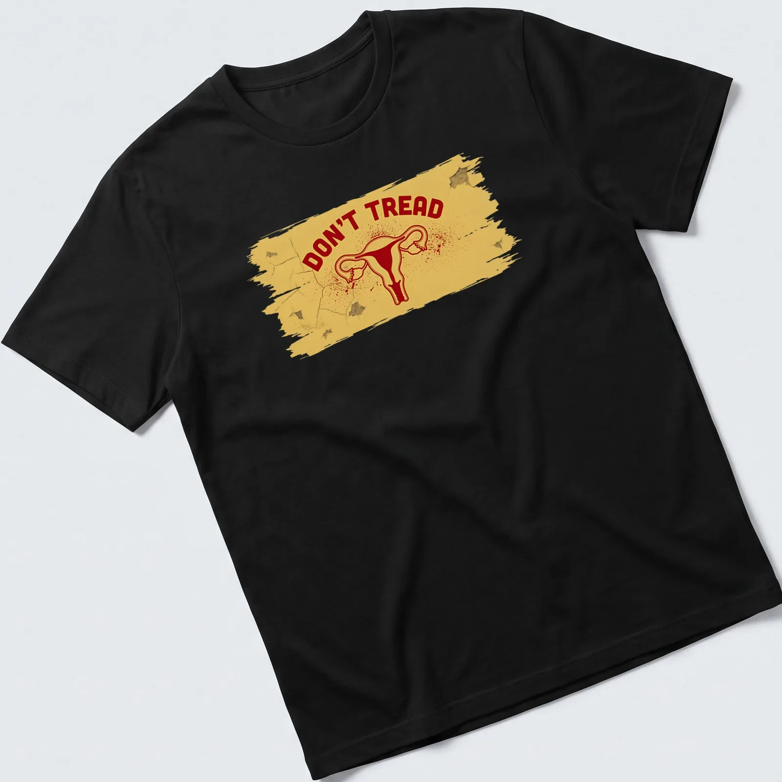 Bold graphic t-shirt featuring uterus and DON'T TREAD text in yellow and red — printed on a unisex t-shirt