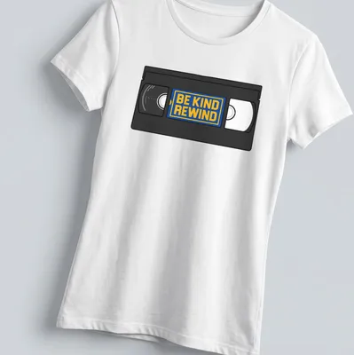 Vintage VHS tape graphic with 'Be Kind Rewind' text in black, yellow, blue, and white. — printed on a women's shirt