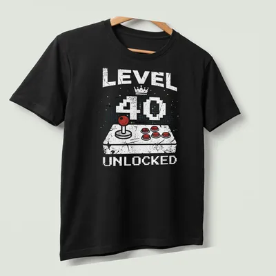 Retro distressed t-shirt featuring a video game controller and level 40 unlocked text — printed on a unisex t-shirt (angled view)