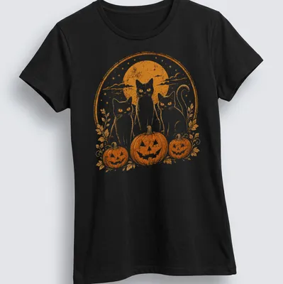 Vintage retro print of three black cats by pumpkins under moonlight — printed on a women's shirt