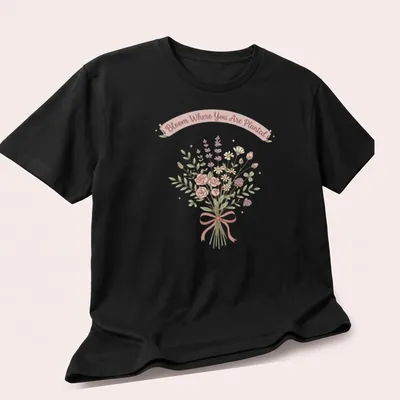 Kawaii line-art wildflower bouquet with the text 'Bloom Where You Are Planted' in pastel colors. — printed on a unisex t-shirt (angled view)