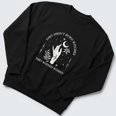 Minimalist design featuring a hand with flowers and a crescent moon alongside bold text — printed on a unisex sweatshirt