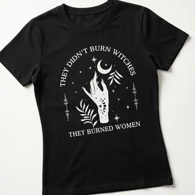 Minimalist design featuring a hand with flowers and a crescent moon alongside bold text — printed on a women's shirt